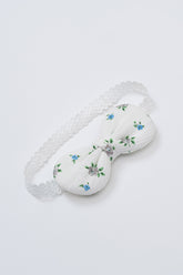 Avauma Petite Garden Baby Headband in Sky Garden, featuring soft white cotton with blue floral embroidery and elastic lace band